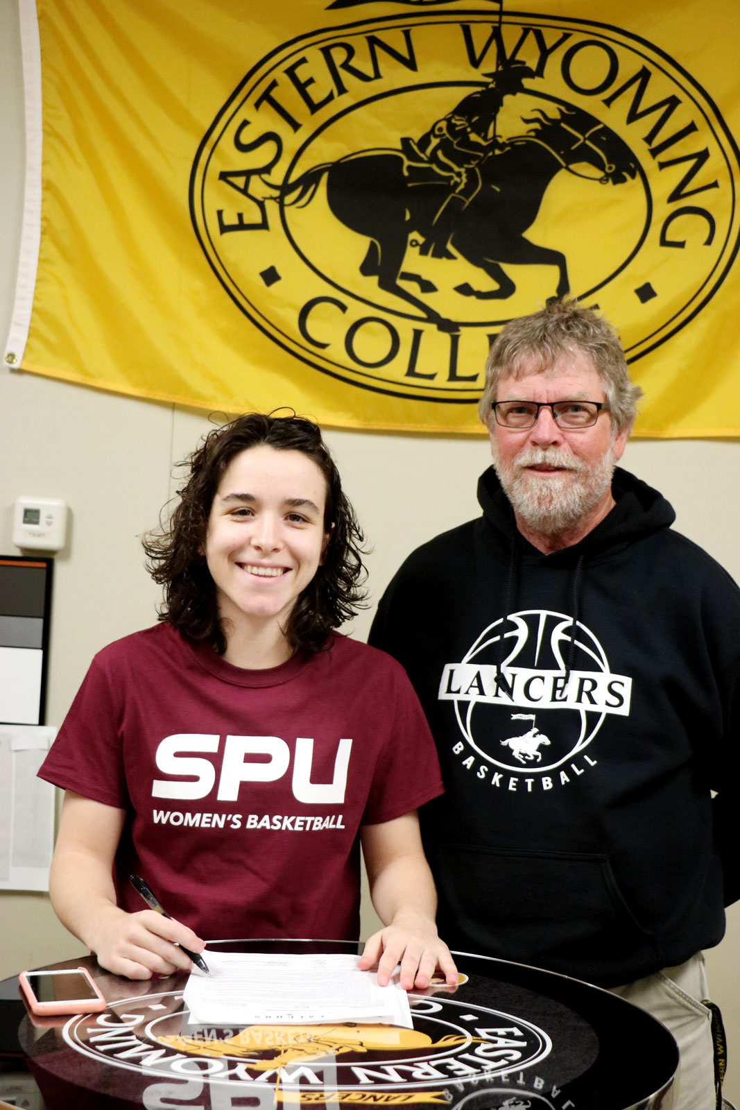 Abril Rexach-Roure with Tom Andersen, EWC’s Head Women’s Basketball Coach as she signs her commitment to Seattle Pacific University.