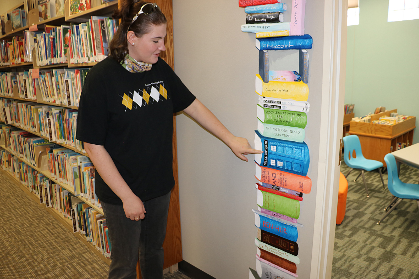 EWC student Winter Hunt explains her artwork created for the Goshen County Library