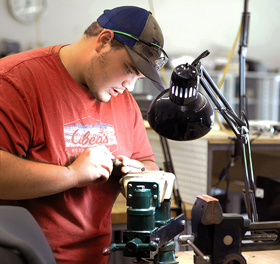 Male Eastern Wyoming ollege Gunsmithing student working on a project in a workshop