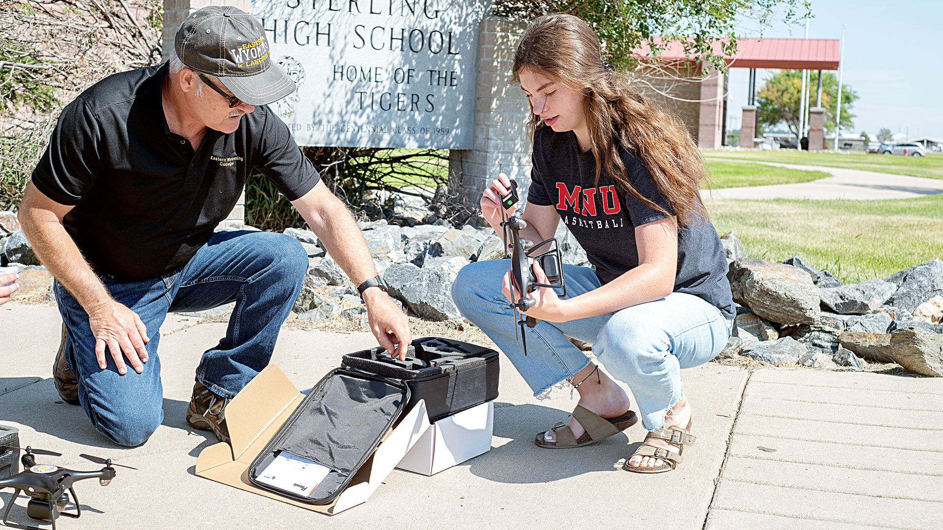 astern Wyoming College Precision Ag Instructor Matt Scott helps Sterling High School graduate Jalyssa Maker setup her new drone. Maker was one of the student winners in EWC's drone giveaway.