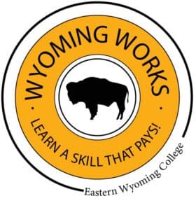 A circular logo with a buffalo silhouette in the center. Text reads “WYOMING WORKS” at the top, “LEARN A SKILL THAT PAYS!” at the bottom, and “Eastern Wyoming College” along the outer edge.