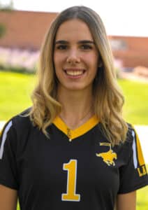 A portrait of a smiling young woman with long blonde hair, wearing a black and gold Lancer jersey with the number 1 and a small gold bear necklace. She is outdoors with a blurred green background.